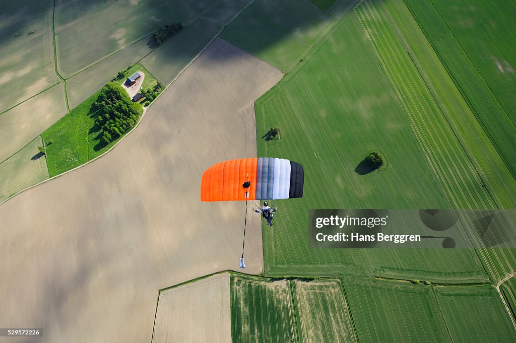 Aerial view of mid adult woman parachuting