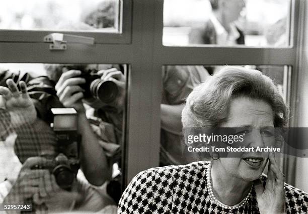 Prime Minister, Margaret Thatcher, photographed under the lenses of photographers covering an election campaign event.