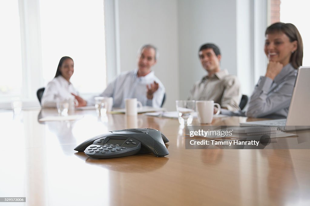 Business colleagues sitting at conference table