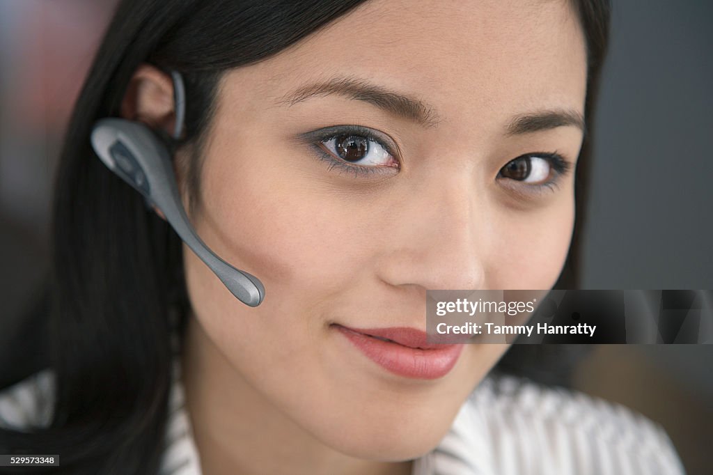 Businesswoman wearing telephone headset