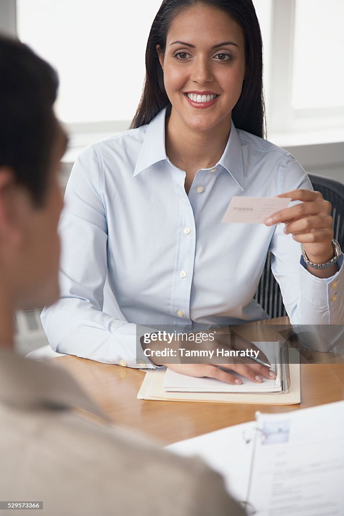 Businesswoman holding business card