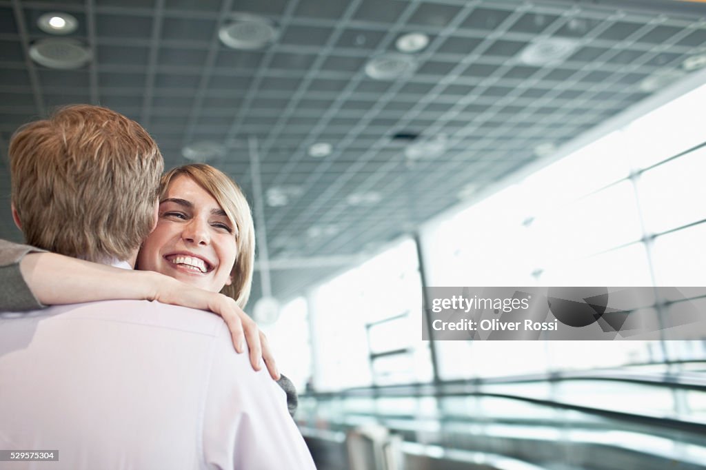 Couple Hugging In Airport Terminal High-Res Stock Photo - Getty Images