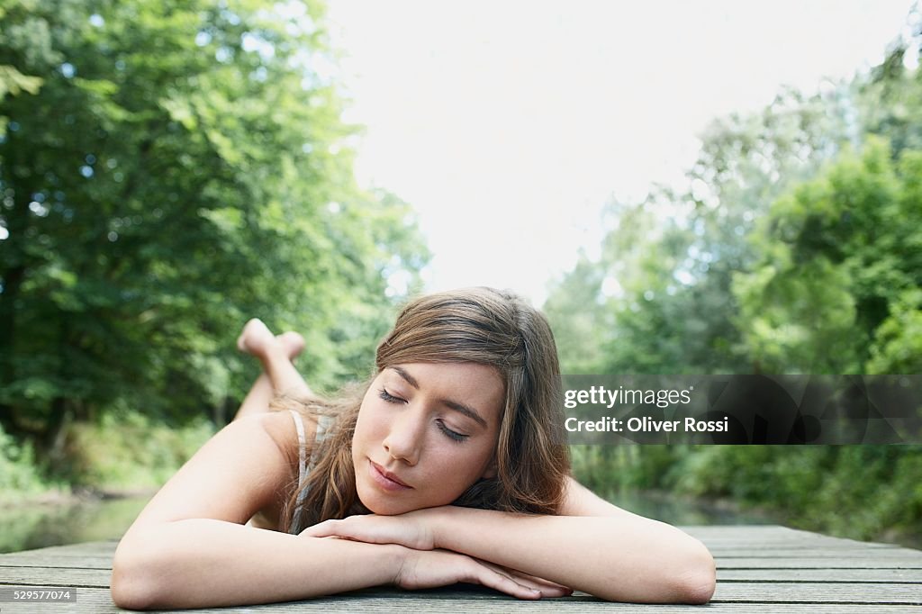 Woman Resting on Dock