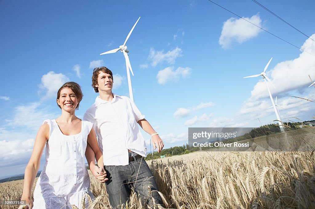 Couple in Field with Windmills