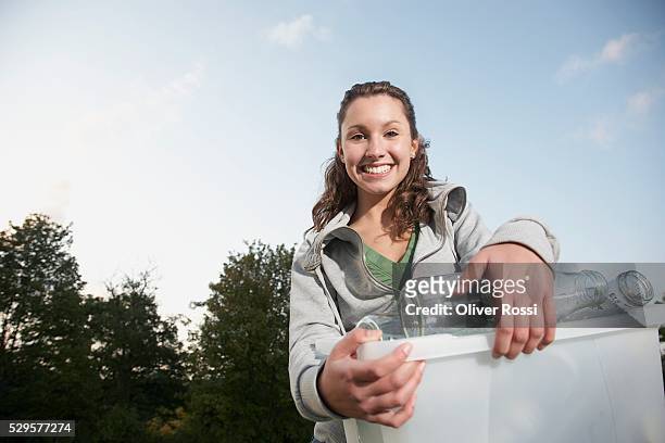woman with recycling bin - altglasbehälter stock-fotos und bilder