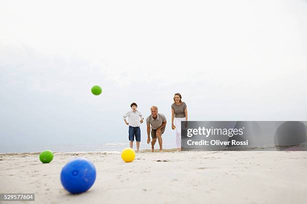 family playing on the beach - bocce ball stock pictures, royalty-free photos & images