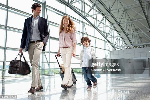 parents with son (5-6) at airport - family airport stock pictures, royalty-free photos & images