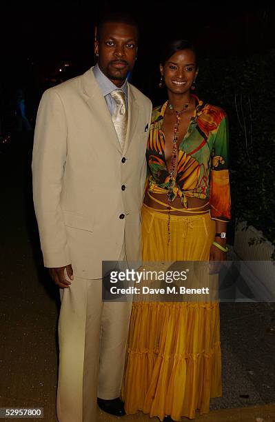 Chris Tucker and his wife attend Naomi Campbell's Le Carnival D'Or Party at Palm Beach on May 19, 2005 in Cannes, France. The gold-tie gala, raising...