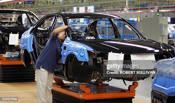 Hyundai employees work on a car on the assembly line 20 May 2005 during the grand opening of their plant in Montgomery, AL. This is the South Korean...