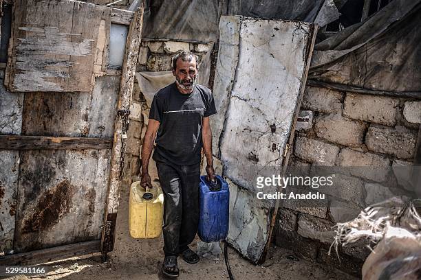 Man carries water buckets as Palestinians face a water crisis in Gaza City, Gaza on May 9, 2016. Palestinians use most of the Gaza's main water...