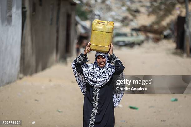 Woman carries a water bucket as Palestinians face a water crisis in Gaza City, Gaza on May 9, 2016. Palestinians use most of the Gaza's main water...