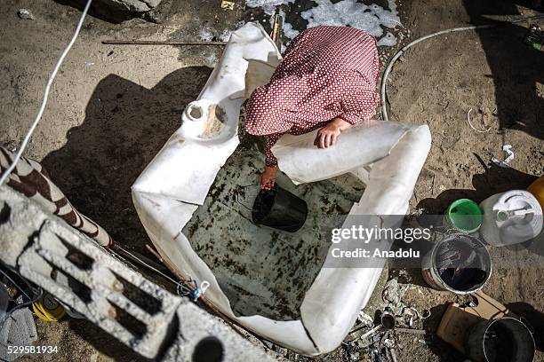 Woman fills a bucket with water brought by a water tank as Palestinians face a water crisis in Gaza City, Gaza on May 9, 2016. Palestinians use most...