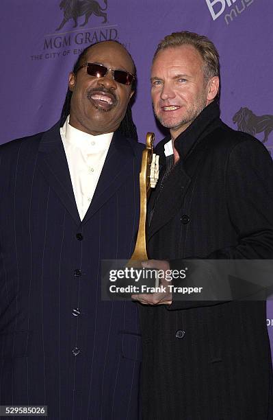 Sting in the press room with his Century Award posing with Stevie Wonder at the 2003 Billboard Music Awards.