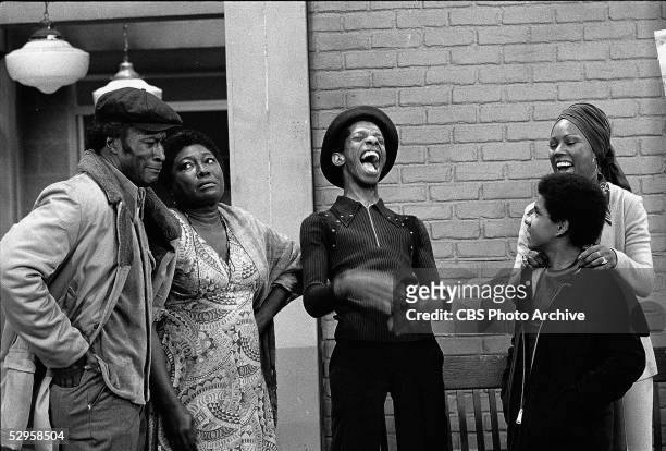 The Evans family and their neighbor Willona share a laugh in a scene from the hit sitcom 'Good Times,' 1974. From left: John Amos, Esther Rolle,...