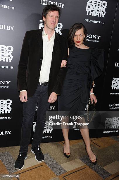 Actress Milla Jovovich and husband, producer Paul W.S. Anderson arrive at the premiere of Zero Dark Thirty held at the Dolby Theater in Hollywood.