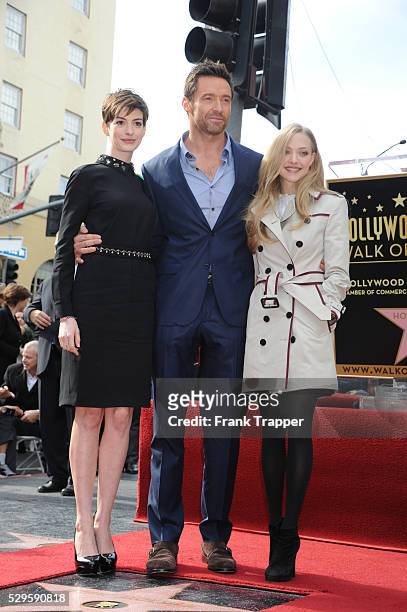 Actors Anne Hathaway, Hugh Jackman and Amanda Seyfried pose at the ceremony that honored him with a Star on the Hollywood Walk of Fame, held in front...