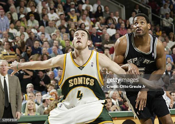 Nick Collison of the Seattle SuperSonics and Robert Horry of the San Antonio Spurs battle for rebounding position in Game three of the Western...