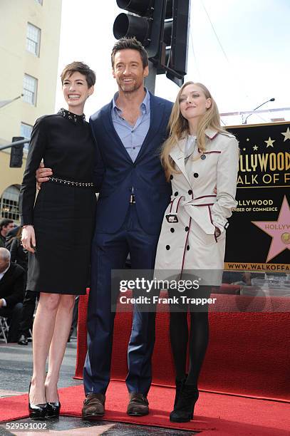 Actors Anne Hathaway, Hugh Jackman and Amanda Seyfried pose at the ceremony that honored him with a Star on the Hollywood Walk of Fame, held in front...