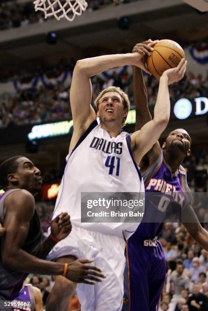 Dirk Nowitzki of the Dallas Mavericks gets fouled by Walter McCarty of the Phoenix Suns but isn't awarded a free throw on the penalty in the second...