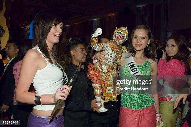 In this handout from Miss Universe L.P, LLLP, Mary Gormley, Miss Ireland 2005, and Amrita Thapar, Miss India 2005, pose with a Thai puppet at the BSC...