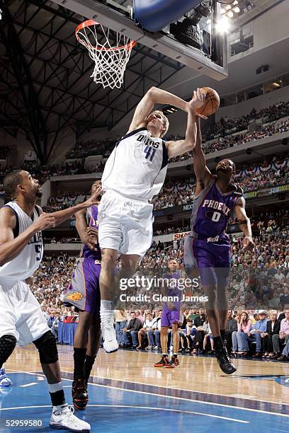Dirk Nowitzki of the Dallas Mavericks attempts to shoot against Walter McCarty of the Phoenix Suns in Game six of the Western Conference Semifinals...