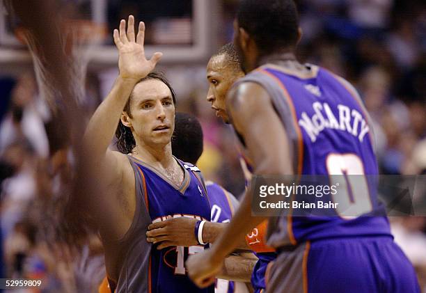 Steve Nash of the Phoenix Suns high-fives Shawn Marion and Walter McCarty against the Dallas Mavericks with time running down in overtime of Game six...