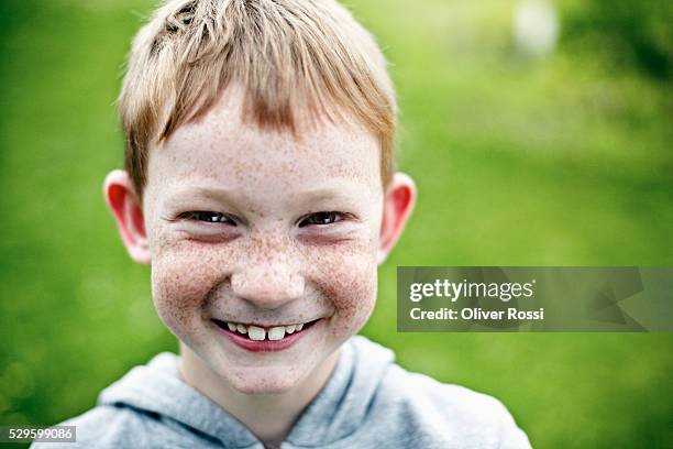 portrait of smiling boy (7-9) with freckles - boy freckle stock pictures, royalty-free photos & images