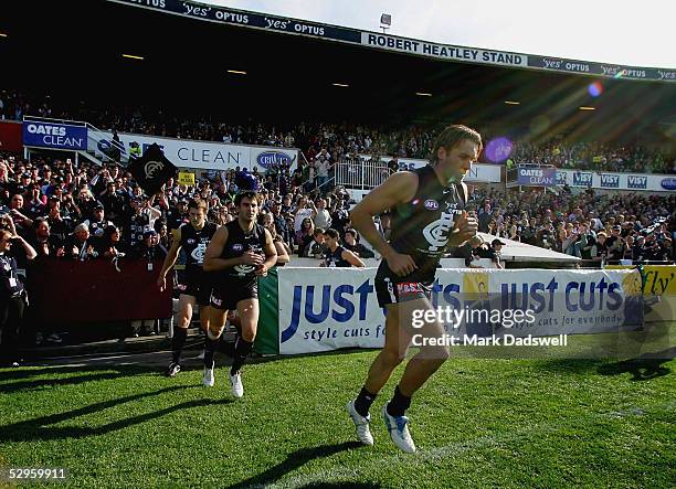 Anthony Koutoufides for the Blues leads his team out for the final time at Optus during the AFL Round 9 match between the Carlton Blues and the...