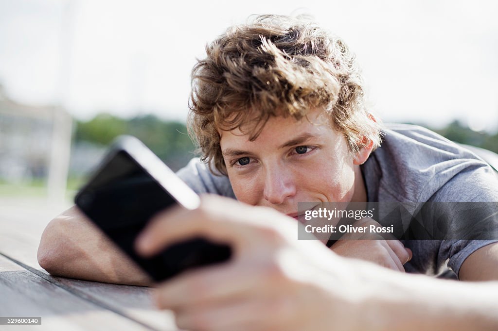 Teen (16-17) boy using cell phone
