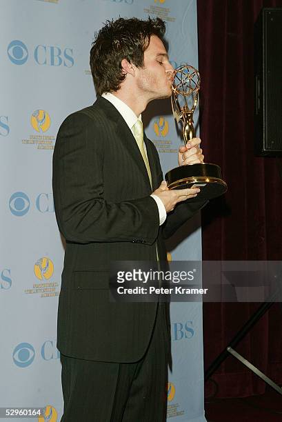 Actor Greg Rikaart poses with the award for outstanding supporting actor in the press room at the 32nd Annual Daytime Emmy Awards at Radio City Music...