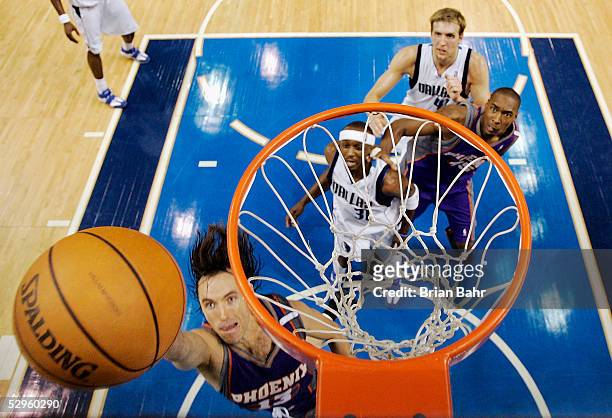 Steve Nash of the Phoenix Suns rolls the ball to the backboard against Jason Terry of the Dallas Mavericks in Game six of the Western Conference...