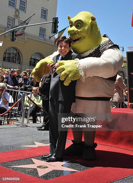 Actor Mike Myers pose with Shrek who was honored on The Hollywood Walk Of Fame.