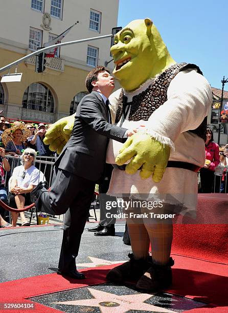 Actor Mike Myers pose with Shrek who was honored on The Hollywood Walk Of Fame.