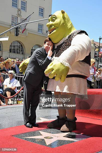 Actor Mike Myers pose with Shrek who was honored on The Hollywood Walk Of Fame.