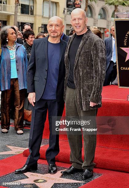 British actor Ben Kingsley posing with actor Bruce Willis after being honored with a Star on the Hollywood Walk of Fame.