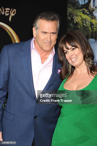 Actor Bruce Campbell and guest arrive at the premiere of Oz: The Great and Powerful held at the El Capitan Theater in Hollywood.