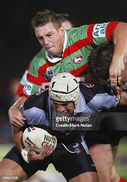 Scott Logan of the Rabbitohs tackles Louis Anderson of the Warriors takes a high ball during the round eleven NRL match between the South Sydney...