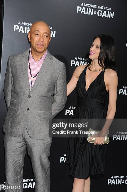 Producer Russell Simmons and guest arrive at the premiere of Pain & Gain held at the Chinese Theater in Hollywood.