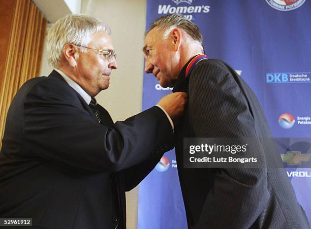 Dr.Theo Zwanziger DFB president presents a special DFB Needle award to Bernd Schroeder coach of Turbine Potsdam after the Women UEFA Cup Final...