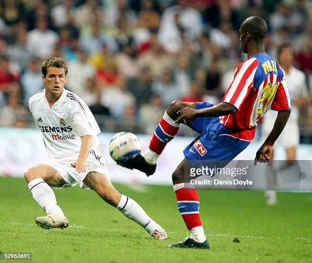Atletico's Luis Perea lobs the ball over Real's Michael Owen during a La Liga match between Real Madrid and Atletico Madrid at the Santiago Bernabeu...