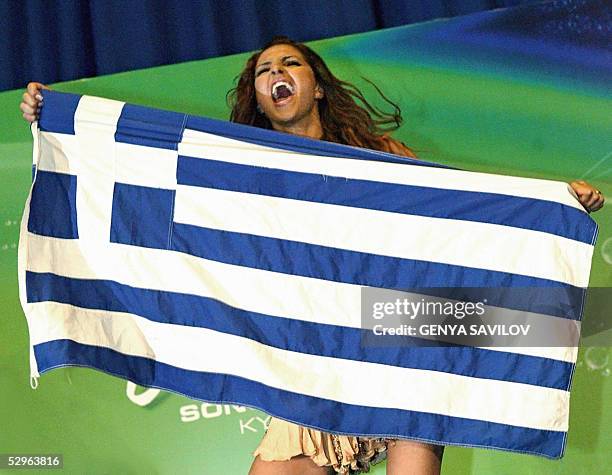 Helena Paparaizou of Greece, winner of 50th Eurovision Song Contest dances on a table with National flag during a press conference in Kiev, 22 May,...