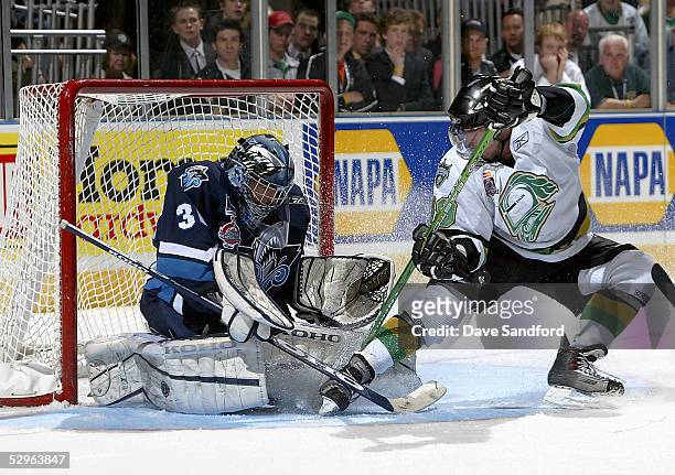 Goalie Cedrick Desjardins of the Rimouski Oceanic stops the puck against Dan Fritsche of the London Knights during the Memorial Cup Tournament at the...