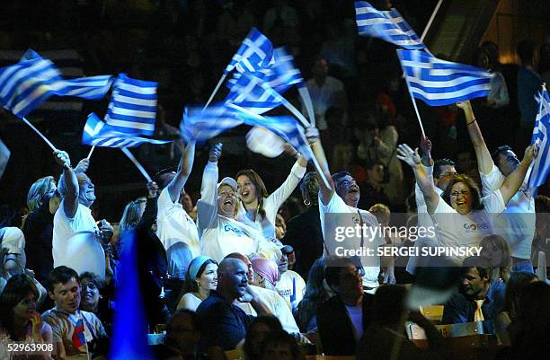 Supporters of singer Helena Paparaizou of Greece jubilate inside the Sport Palace in Kiev, 22 May after Helena won the 50th Eurovision Song Contest...