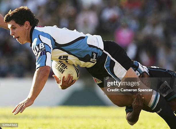 Greg Bird of the Sharks is tackled during the round 11 NRL match between the Penrith Panthers and the Cronulla-Sutherland Sharks at Penrith Stadium...