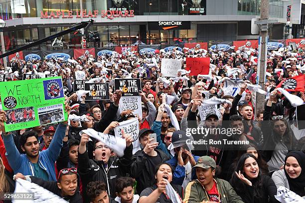 Fans cheer from outside the arena in "Jurassic Park" for the Toronto Raptors in Game Two of the Eastern Conference Semifinals against the Miami Heat...