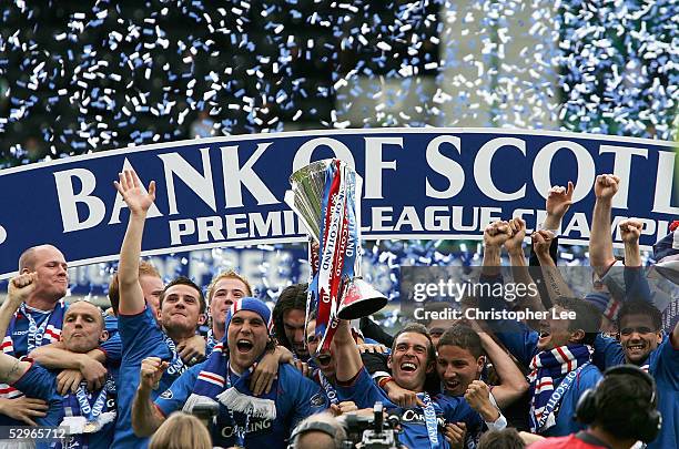 Captain Fernando Ricksen of Rangers lifts the Scottish Premier League trophy as his team mates celebrate during the Bank of Scotland Scottish Premier...