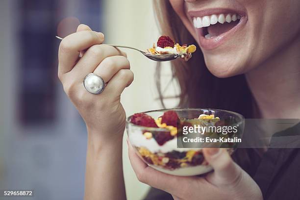 having breakfast - women yogurt stock pictures, royalty-free photos & images