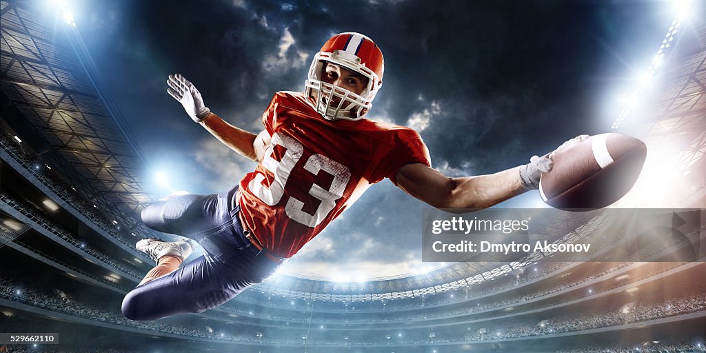 Football player catches a ball