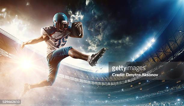 football player runs with the ball - football stock pictures, royalty-free photos & images
