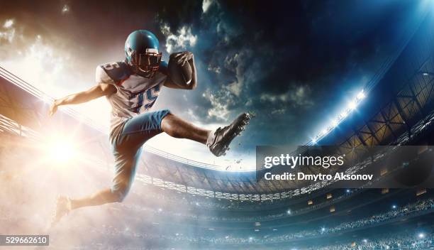 football player runs with the ball - american culture bildbanksfoton och bilder